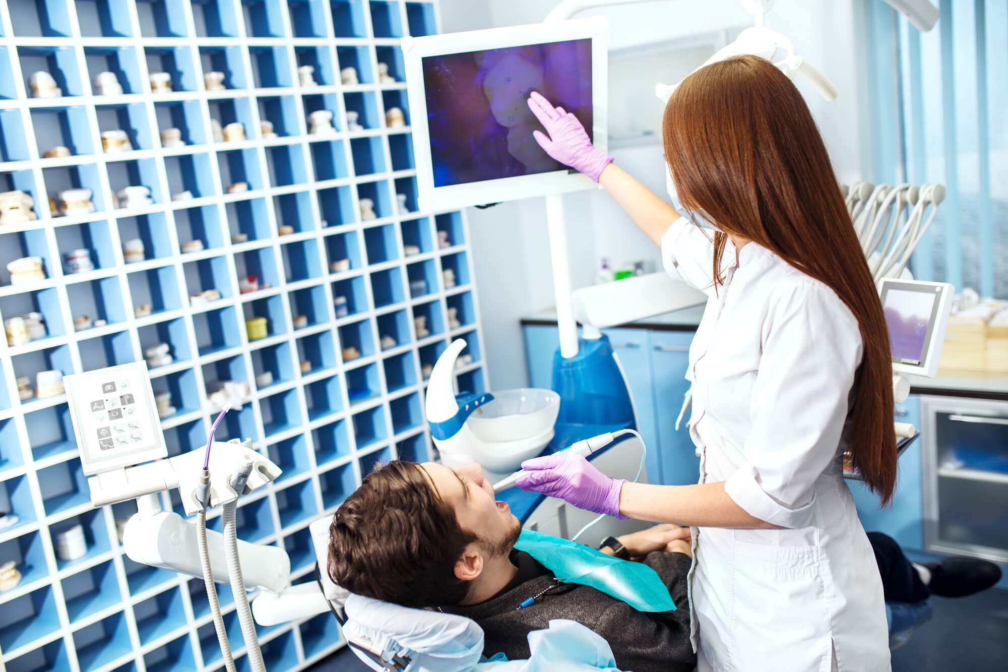 dentist explaining Root Canal Pompano Beach to a patient