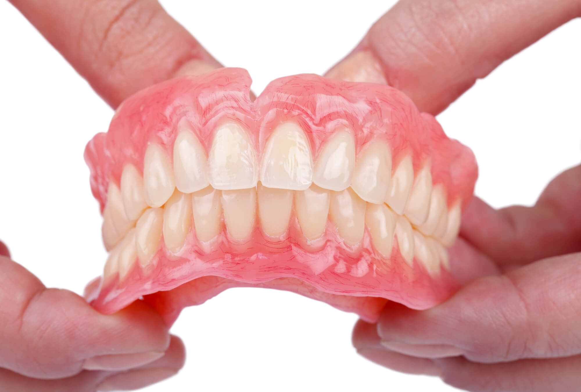 dentist holding Dentures Pompano Beach